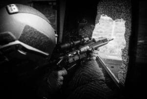 A person holding an ar-1 5 rifle in their hand.