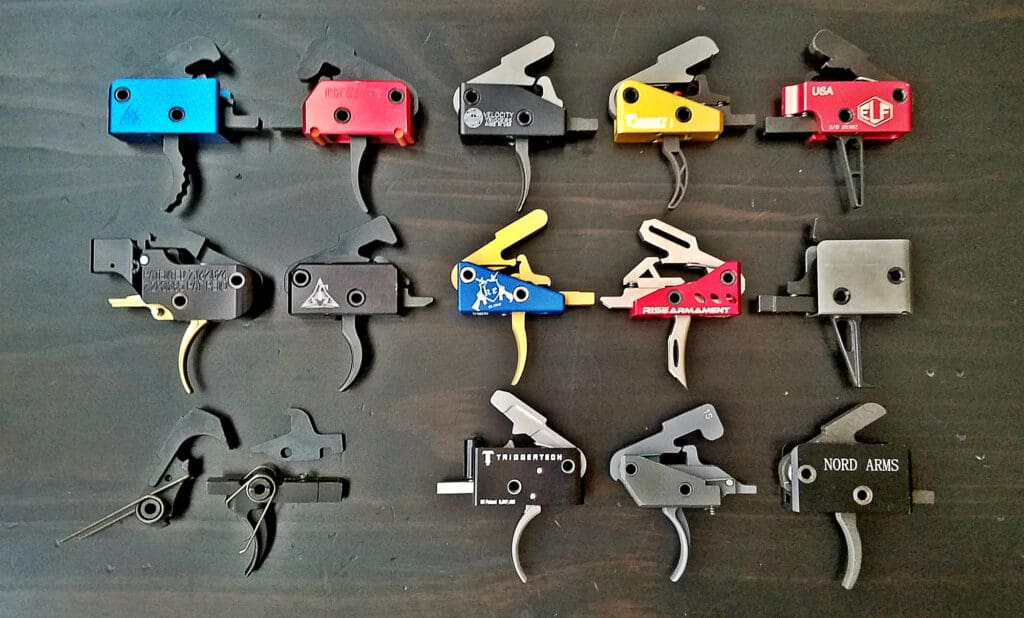 A bunch of different color guns are lined up on the table